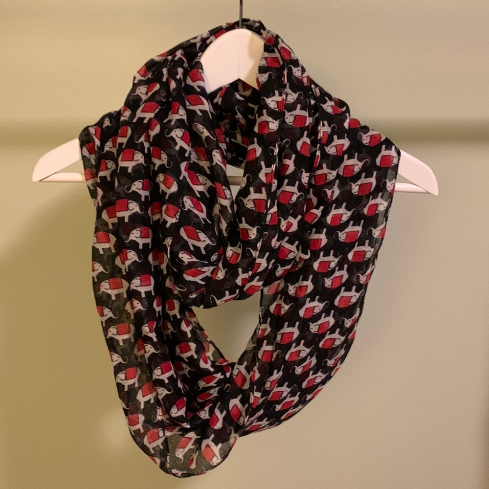 Black infinity scarf with red and white elephant pattern.